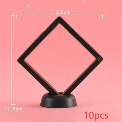 3D floating display case holding a coin suspended between transparent membrane sheets, black frame