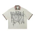 Men's loose blue cotton top with asymmetric lapel and graffiti print, short sleeves.