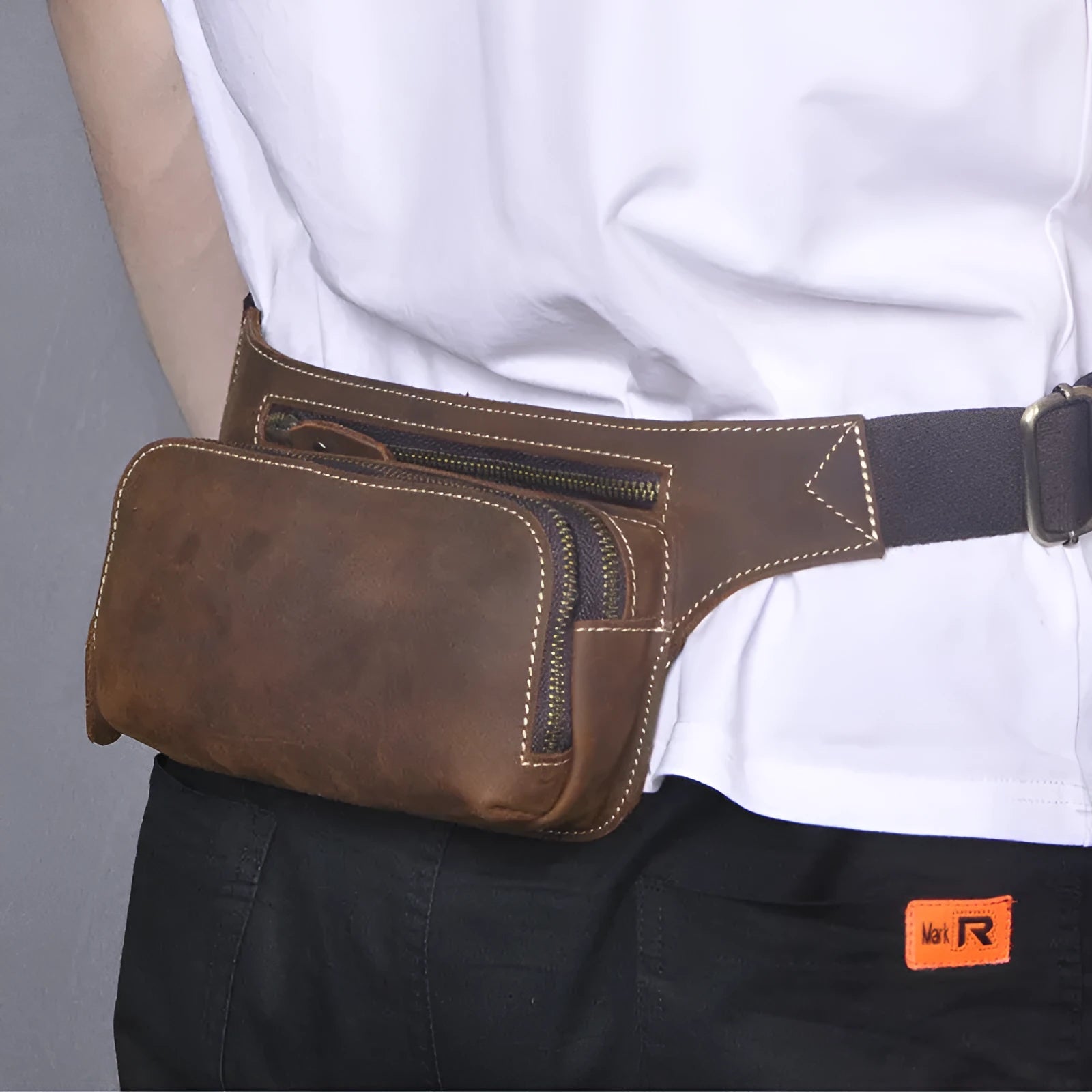 Brown men's cowhide sports waist bag shown from the front, highlighting the pull closure and compact 30cm wide design.