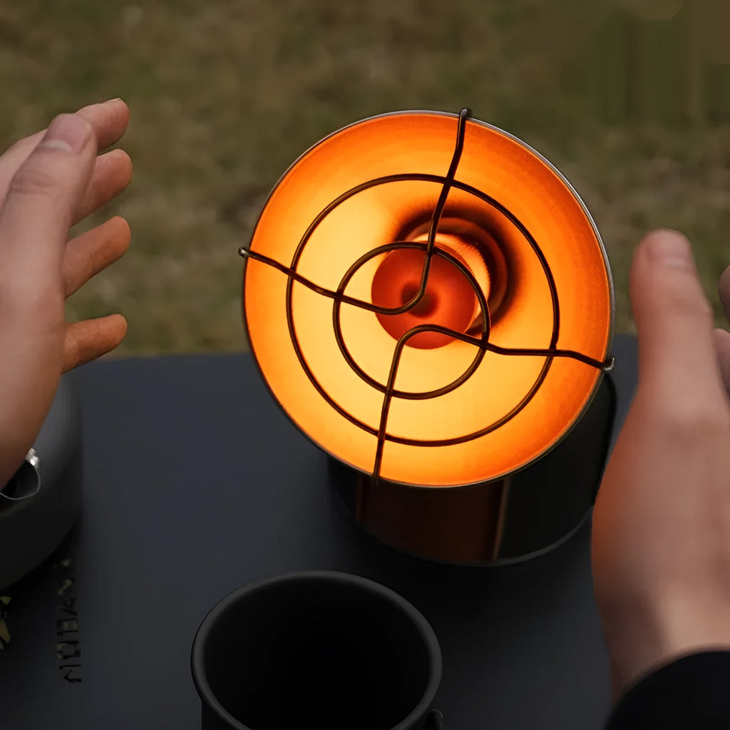 Black and orange portable camping heating stove with automatic ignition.