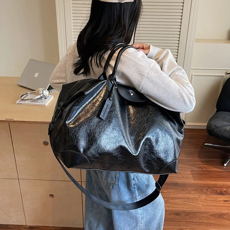 Women's hand-carry travel bag with 36-55L capacity in black or silver colour