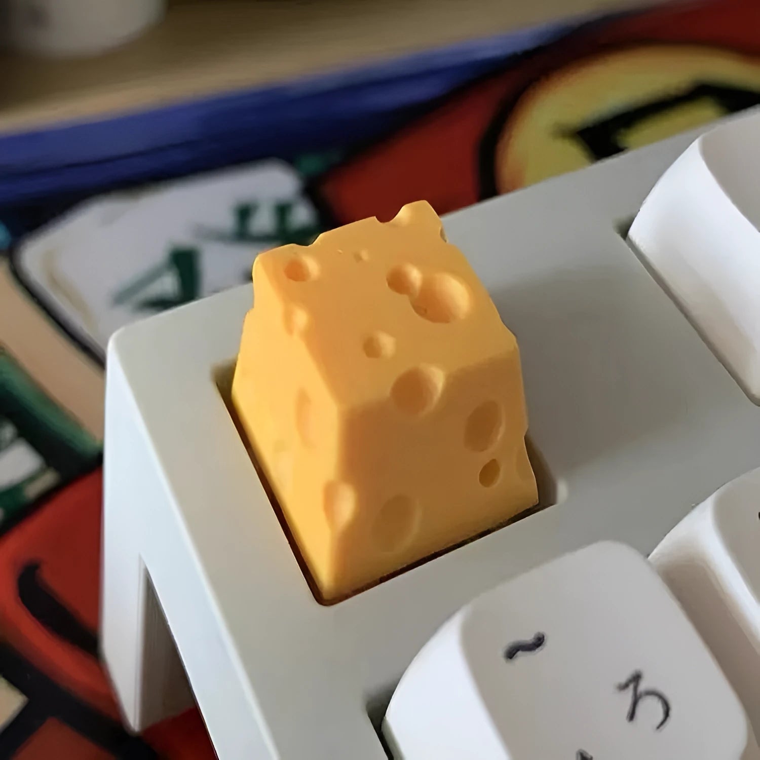 Yellow resin mechanical keyboard keycap sculpted like a wedge of Swiss cheese.