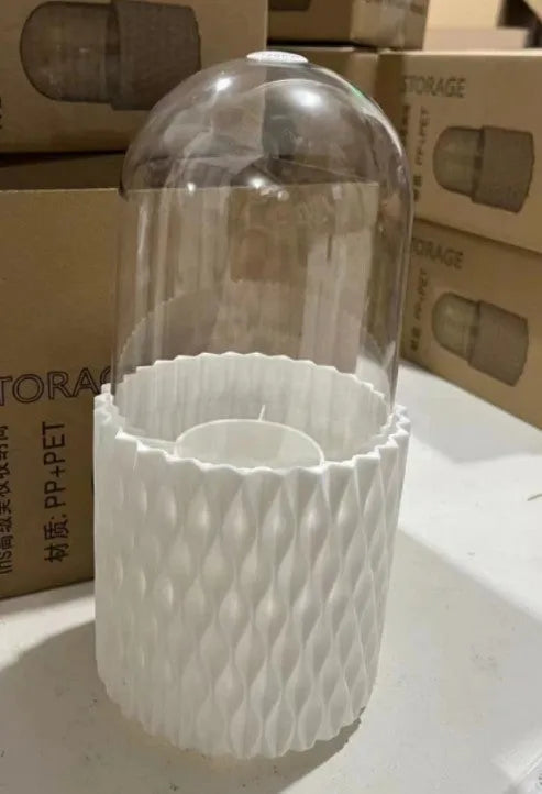 White acrylic rotating makeup brush holder with transparent dust cover showing split storage compartments