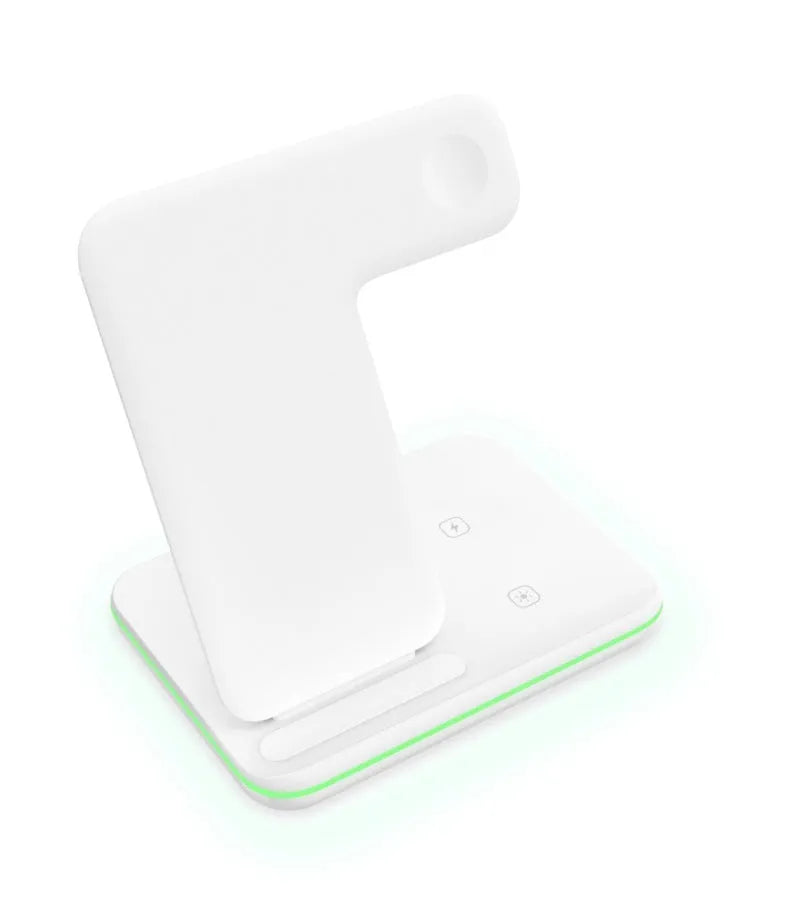 White three-in-one wireless charging stand for mobile phone, smartwatch, and headset on a desk.