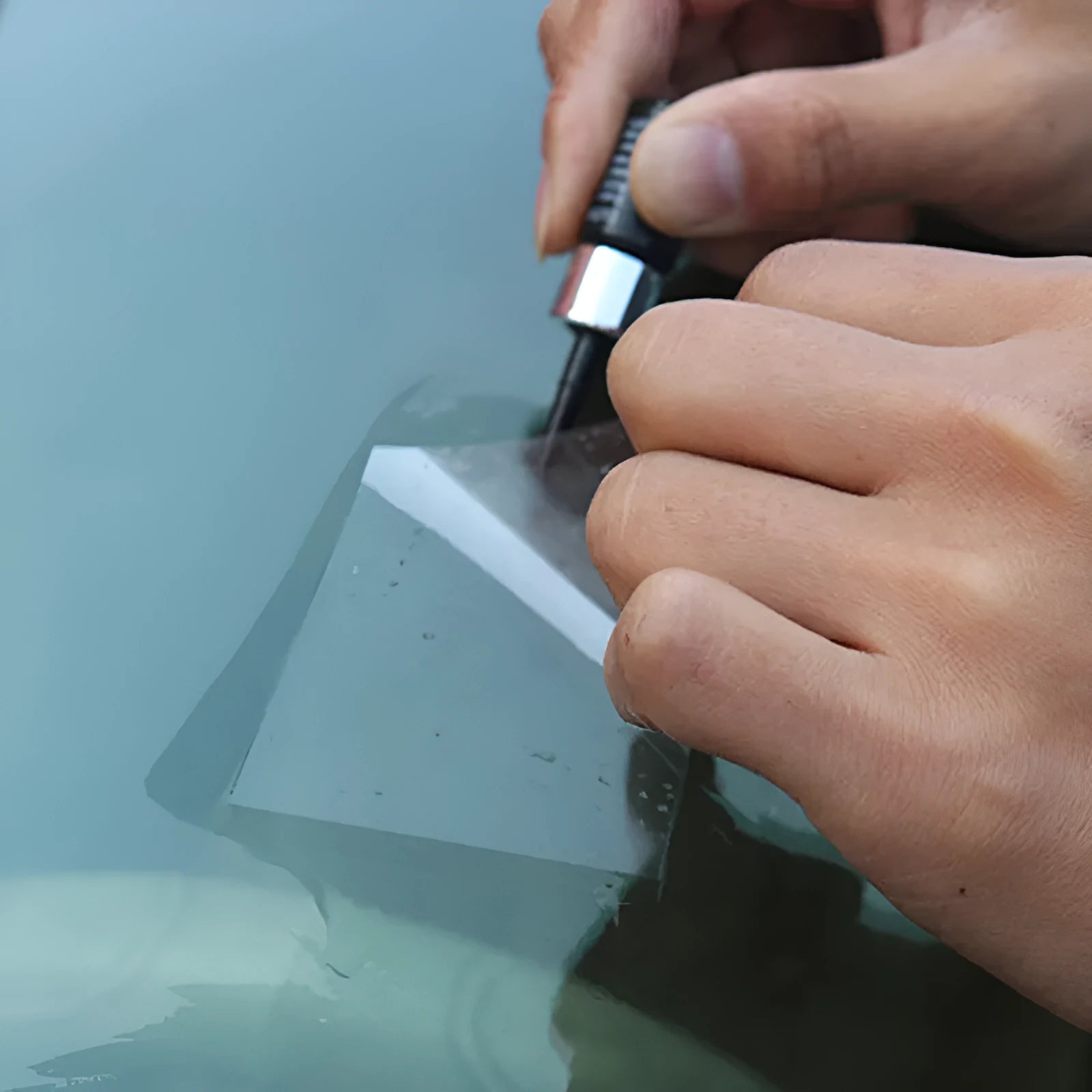 Yellow car windscreen repair kit with UV resin bottle, injection tool, and curing lamp for DIY glass crack repair
