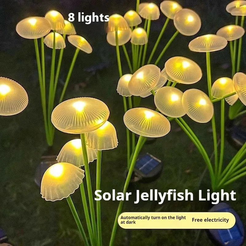 Solar jellyfish silicone garden lamp with warm LED lights on grass.