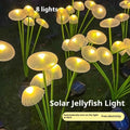 Solar jellyfish silicone garden lamp with warm LED lights on grass.