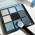 MUGELEEN nine-colour eyeshadow palette showing low saturation blue and earth tones with diamond debris effect