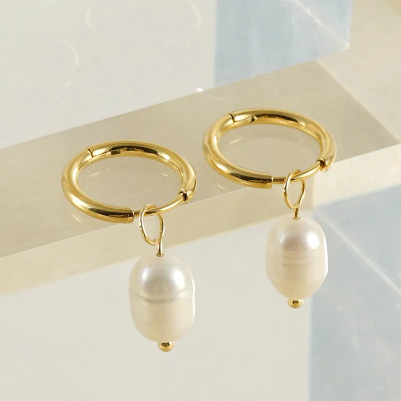 Gold geometric stainless steel earrings with a white pearl accent for women.