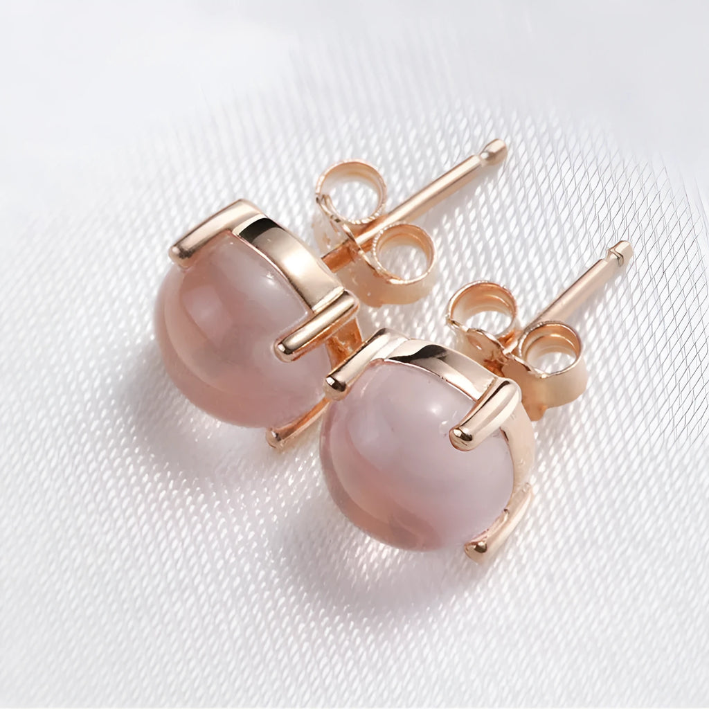 Women's rose gold drop shape stud earrings with synthetic ross quartz crystal inlay