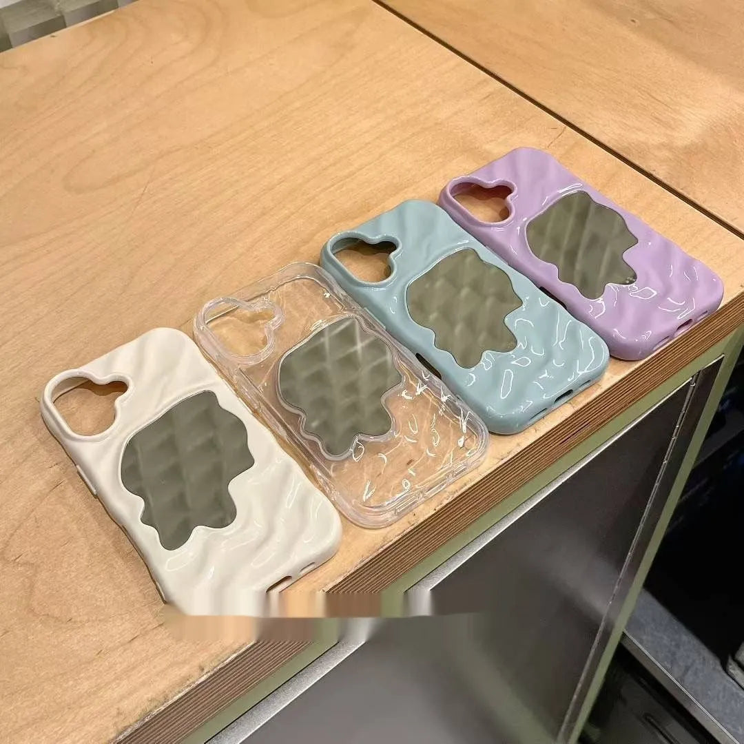 Water ripple texture solid colour mirror phone case for iPhone on a table.