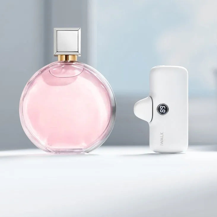 Small white cylindrical lipstick-shaped power bank showing digital battery percentage display on its side.