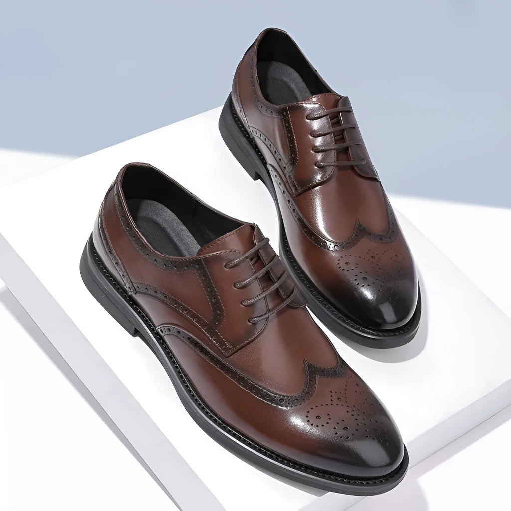 Men's classic brown brogue leather business shoes on a white background.