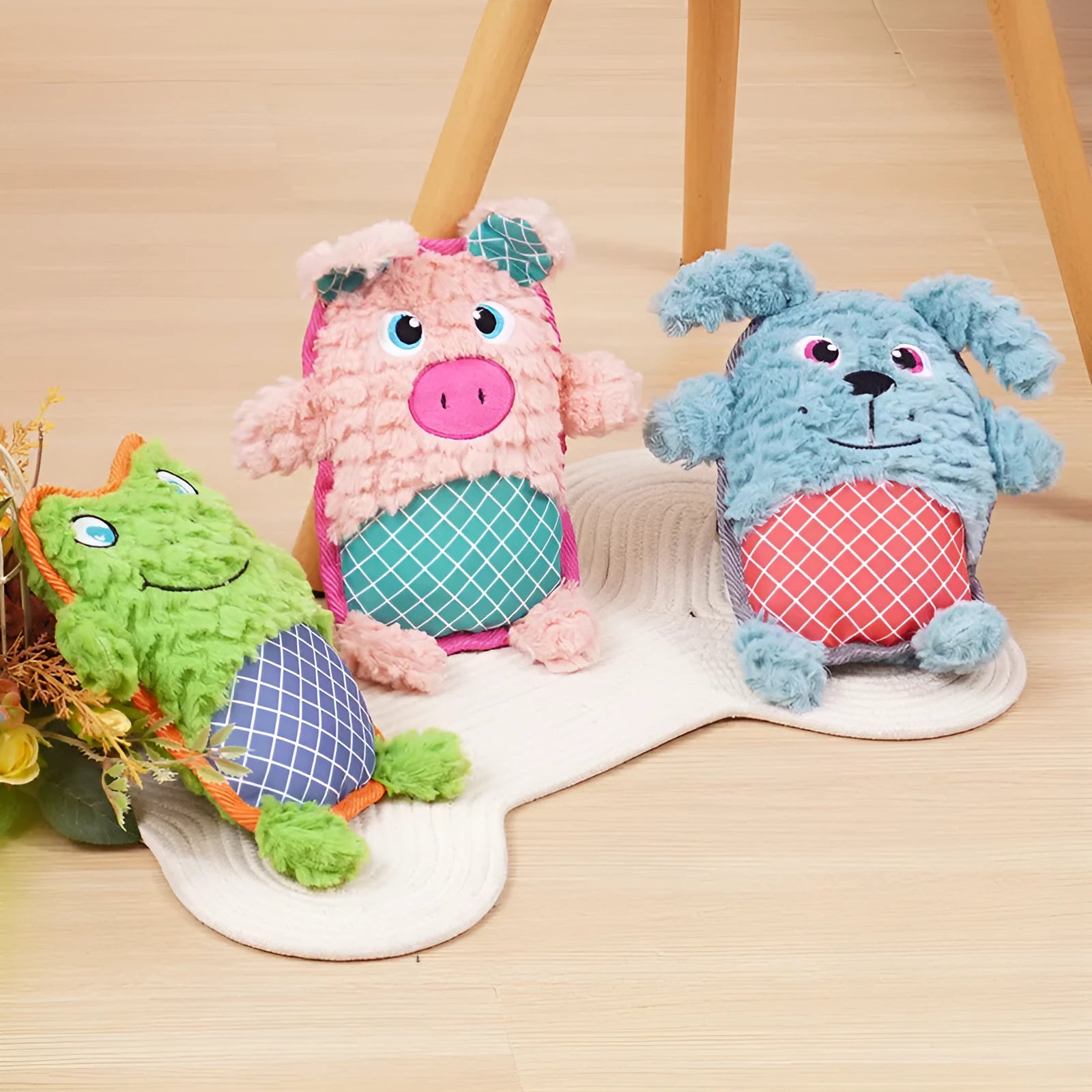 Blue bite-resistant stuffed dog toy with squeaker, safe for molar teeth, next to green and pink versions.