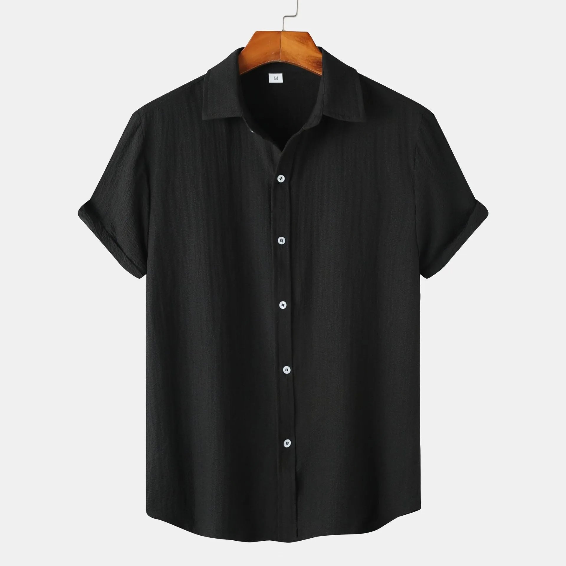 Men's casual short-sleeved polyester shirt in cardigan style on a hanger