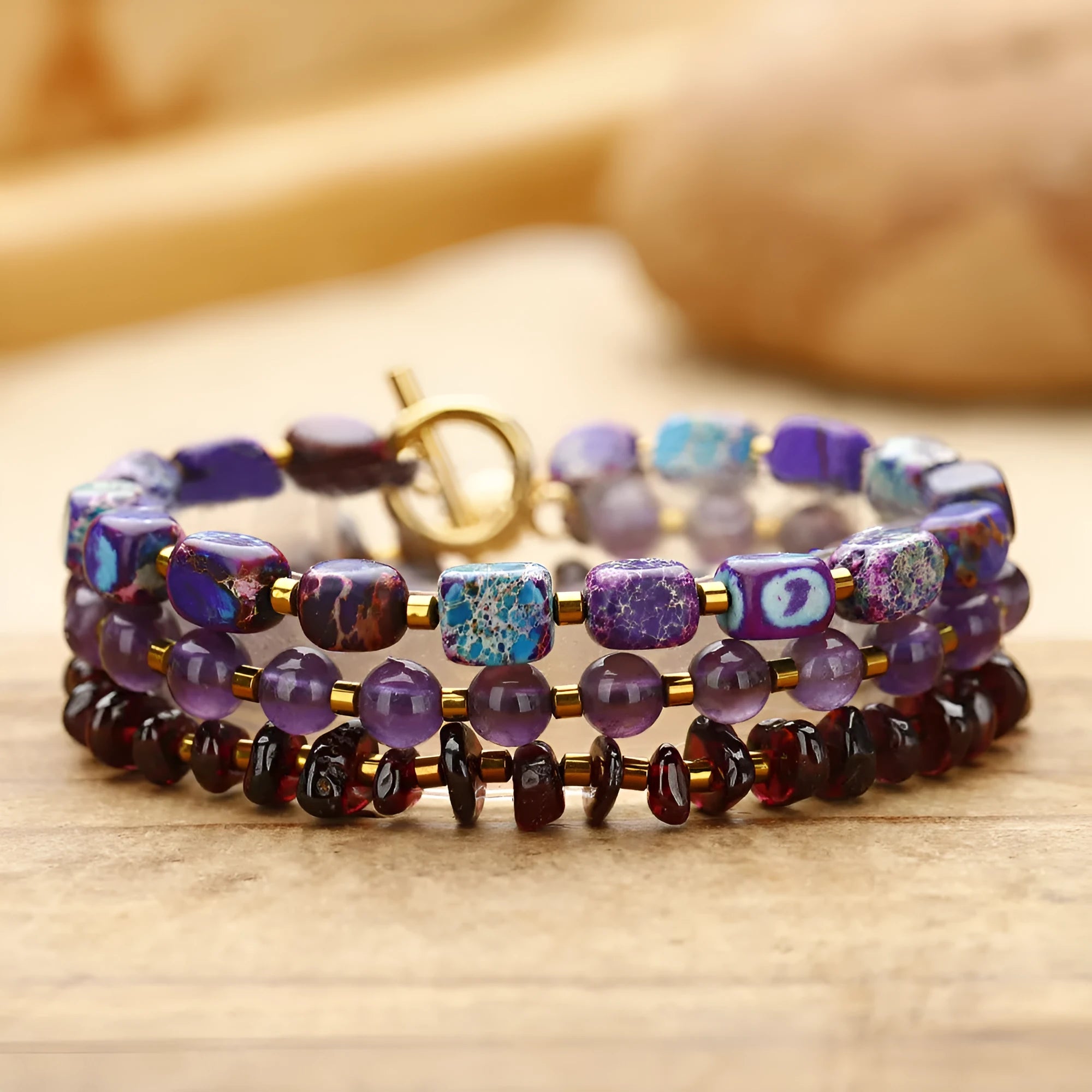 Purple amethyst and garnet round stone bead bracelet with geometric shapes