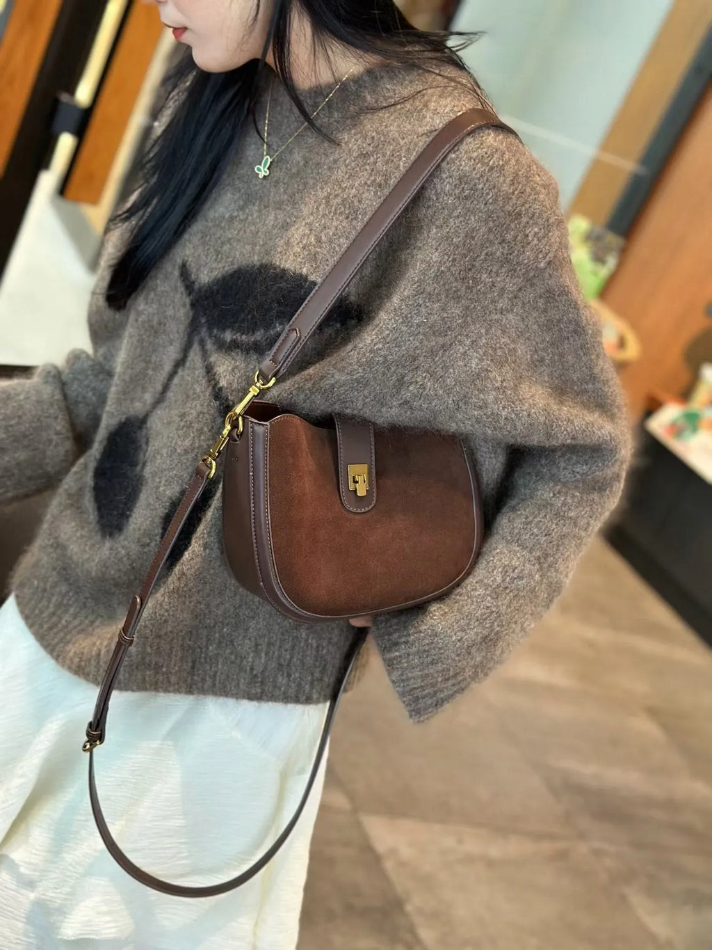 Women's black genuine leather crossbody bag with one-shoulder design and sandwich pocket exterior
