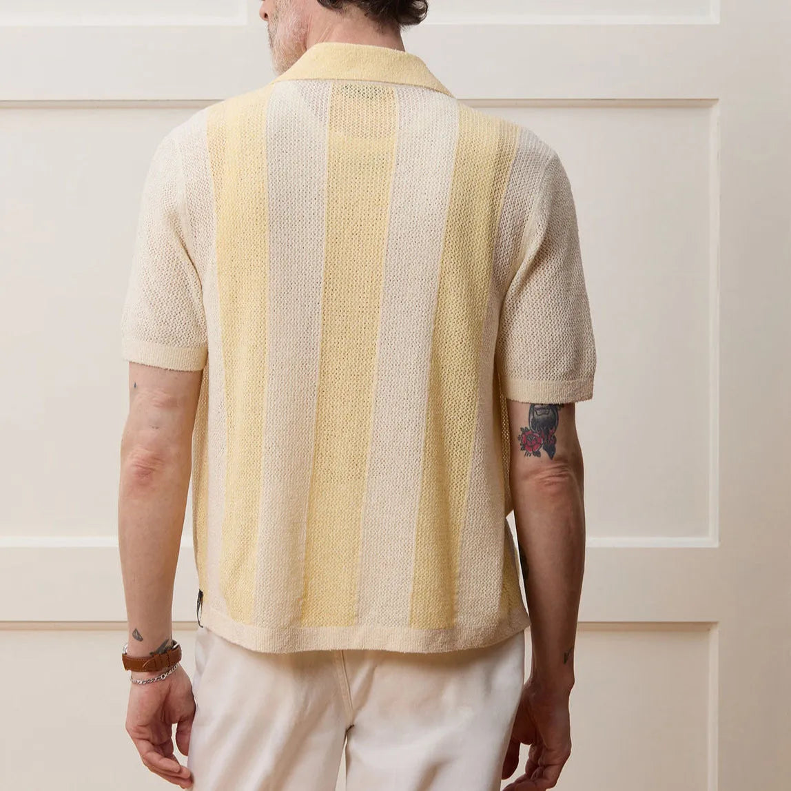 Yellow casual polo shirt with hollow-out design and asymmetric cut, short sleeves, made from Tencel fabric.