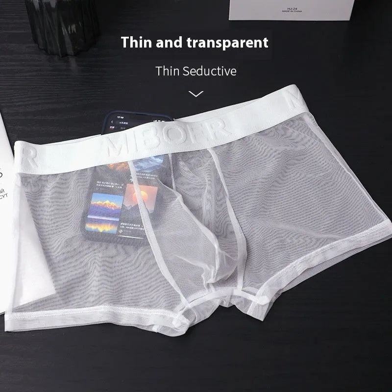 Men's thin polyester boxer shorts in solid colours including black, white, blue, and pink