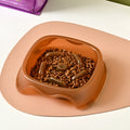 Blue plastic slow feeder dog bowl with internal ridges to prevent choking.