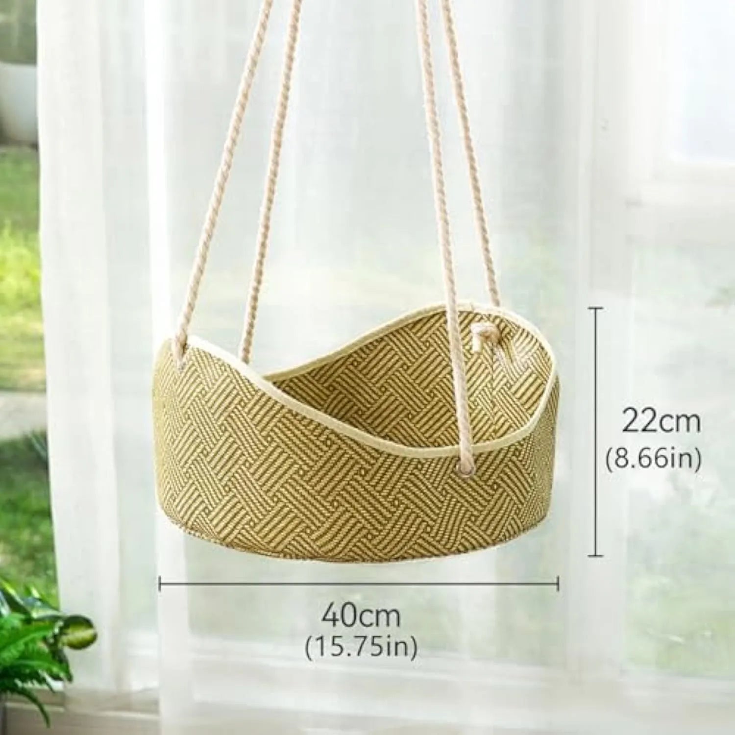 Green rattan cat hammock with metal hooks hanging from a shelf