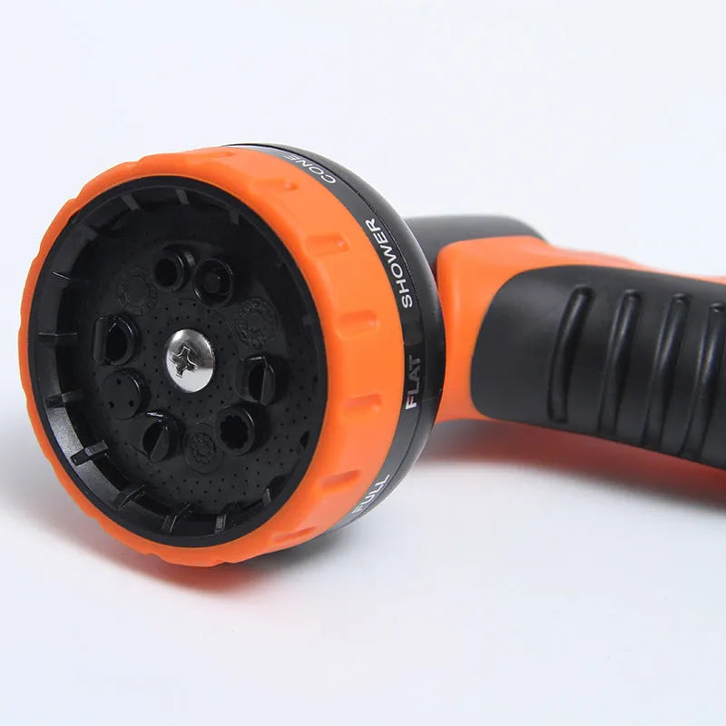 High pressure car wash gun with 30m plastic hose and adjustable spray patterns on driveway