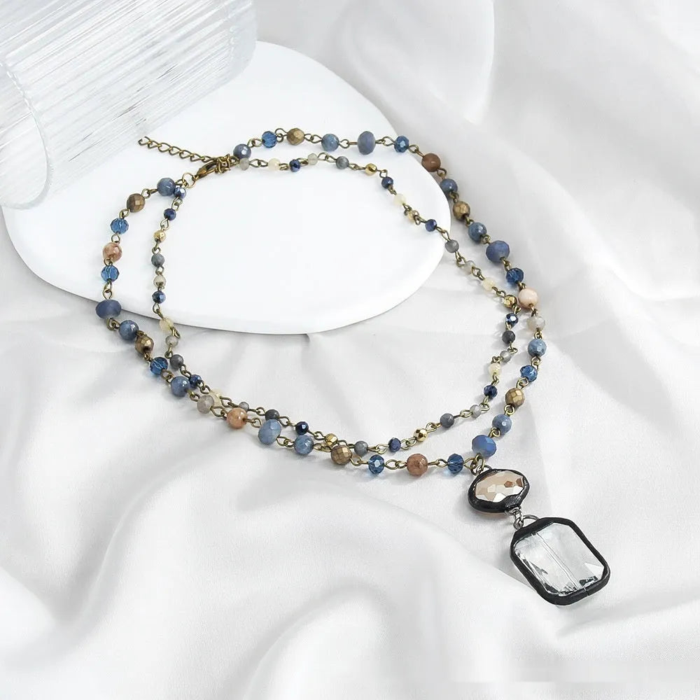 Two-layer tribal necklace with glass pendant and natural stone elements on adjustable chain