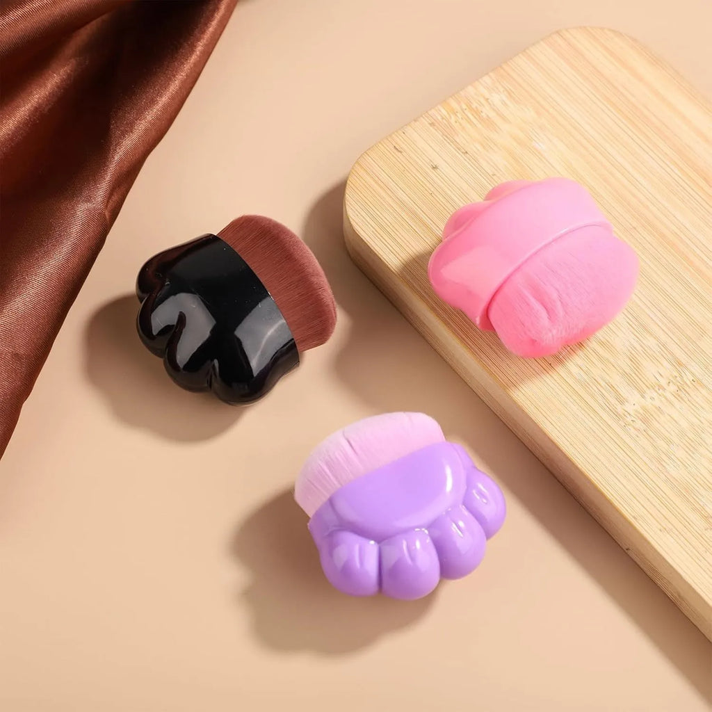 Three paw-shaped pet balm brushes with soft fibre heads in plastic storage boxes