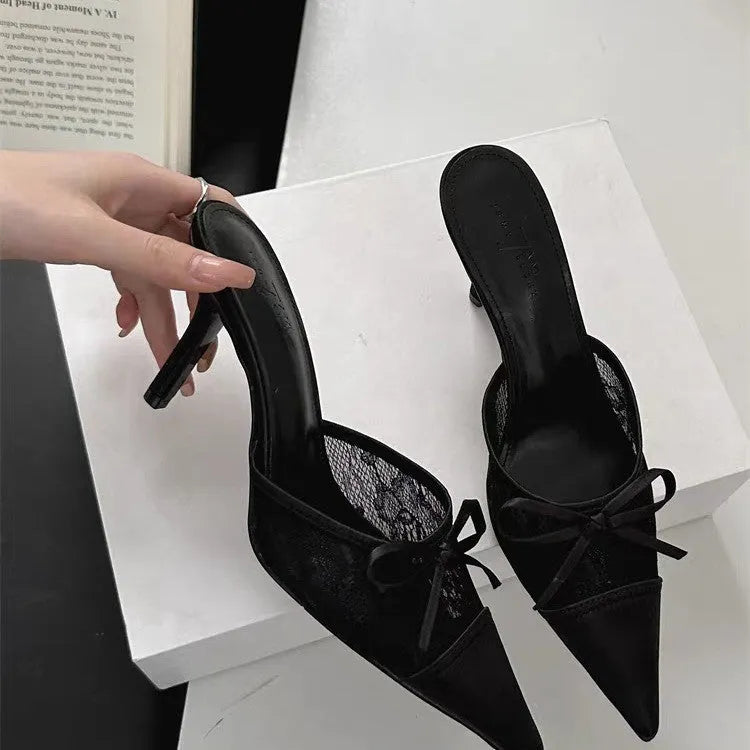 Women's light brown high heels with a pointed toe, decorative bowknot, and mesh upper.