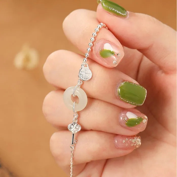 Women's silver bracelet with Hetian jade and geometric peace buckle design in Chinese style