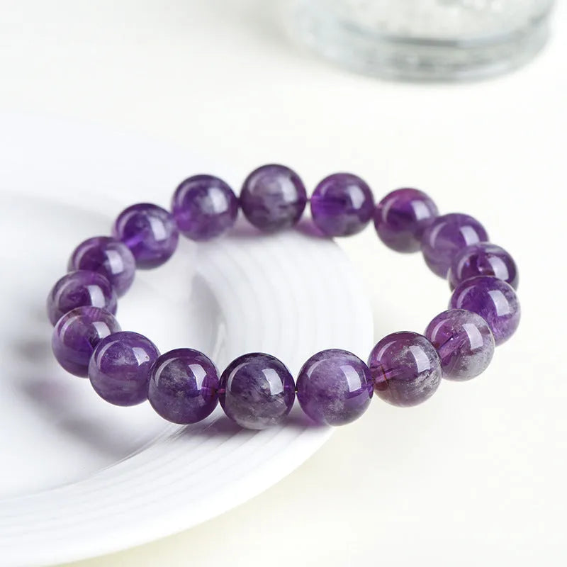Natural feather amethyst crystal bracelet with geometric beads and Ruyi symbol in Snow Mountain purple.