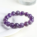 Natural feather amethyst crystal bracelet with geometric beads and Ruyi symbol in Snow Mountain purple.