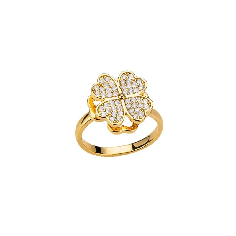 Rotatable flower ring with rhinestones on a woman's finger, available in gold or platinum finish