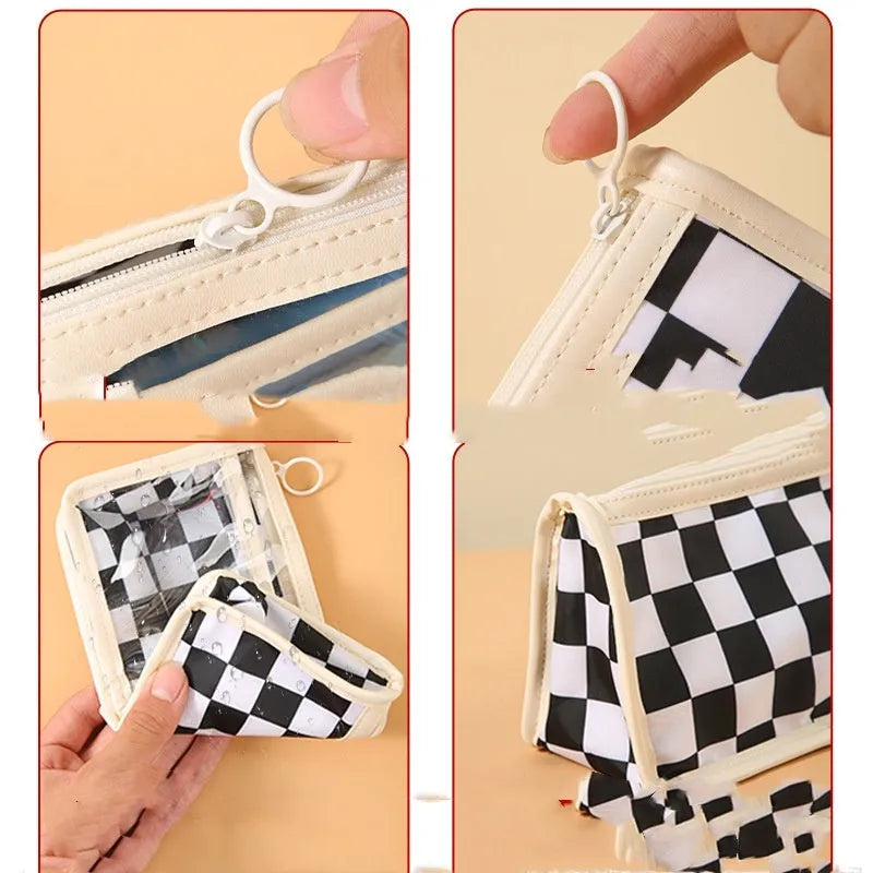 Large transparent PVC pencil case with internal black and white chessboard grid design.