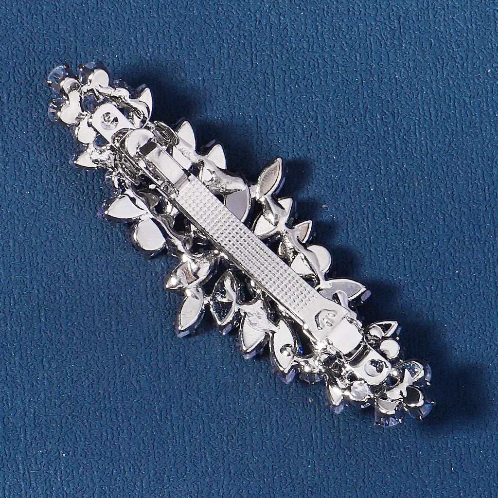 Women's inlaid zircon spring clip barrettes with electroplated leaf design on a neutral background