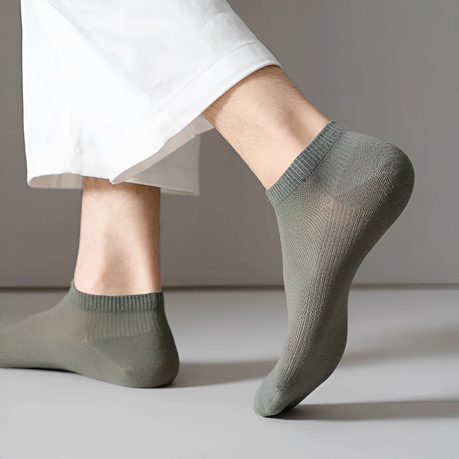 A pair of solid-colour, low-cut boat socks for men made from breathable polyester, shown in one of the six available shade options.