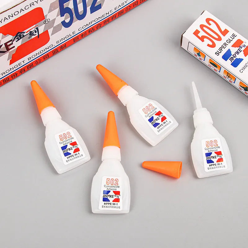 Tube of instant strong adhesive glue for shoe and leather repair with applicator tip.