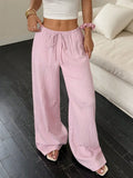 Women's black wide-leg trousers with a front lace-up waist detail, shown in a casual standing pose.