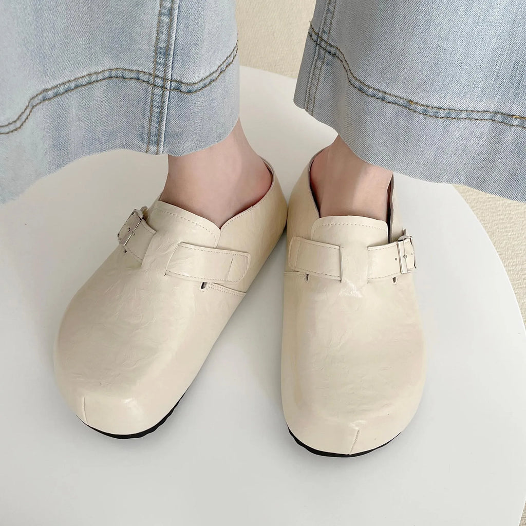 Flat buckle casual slippers with round toe and PU upper in beige colour on a clean surface
