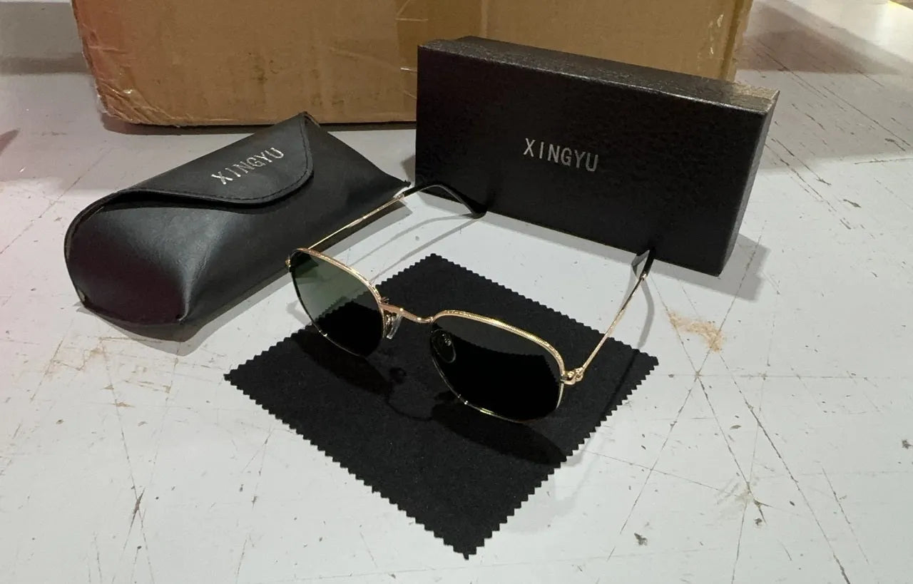 Classic round polarised sunglasses for men in gun metal grey with adjustable nose pads on a wooden table.
