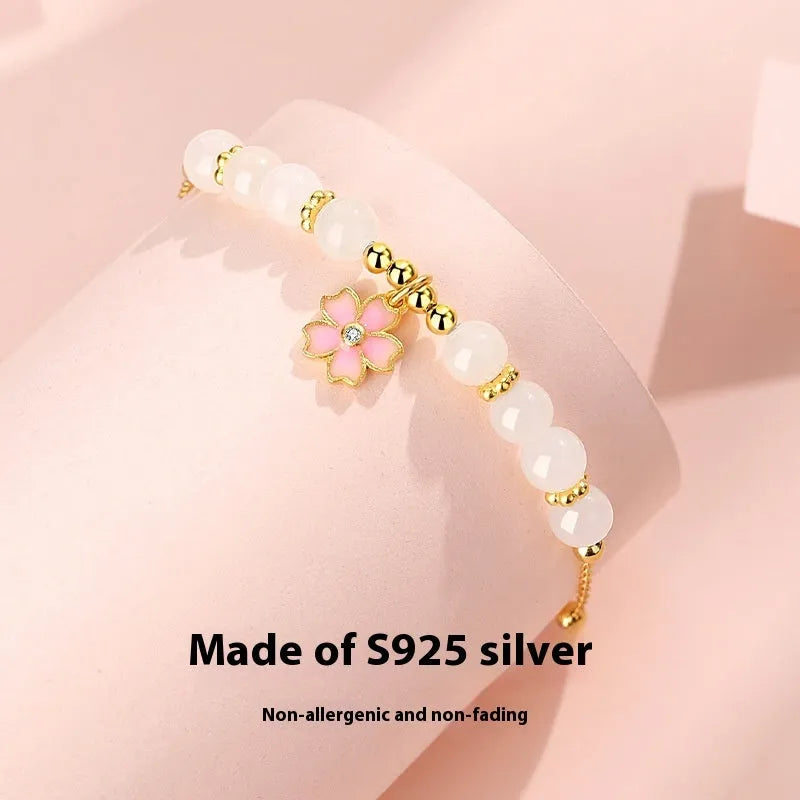 Pink women's bracelet with 925 silver cherry blossom pendant, Hetian jade beads, and gradient epoxy details.