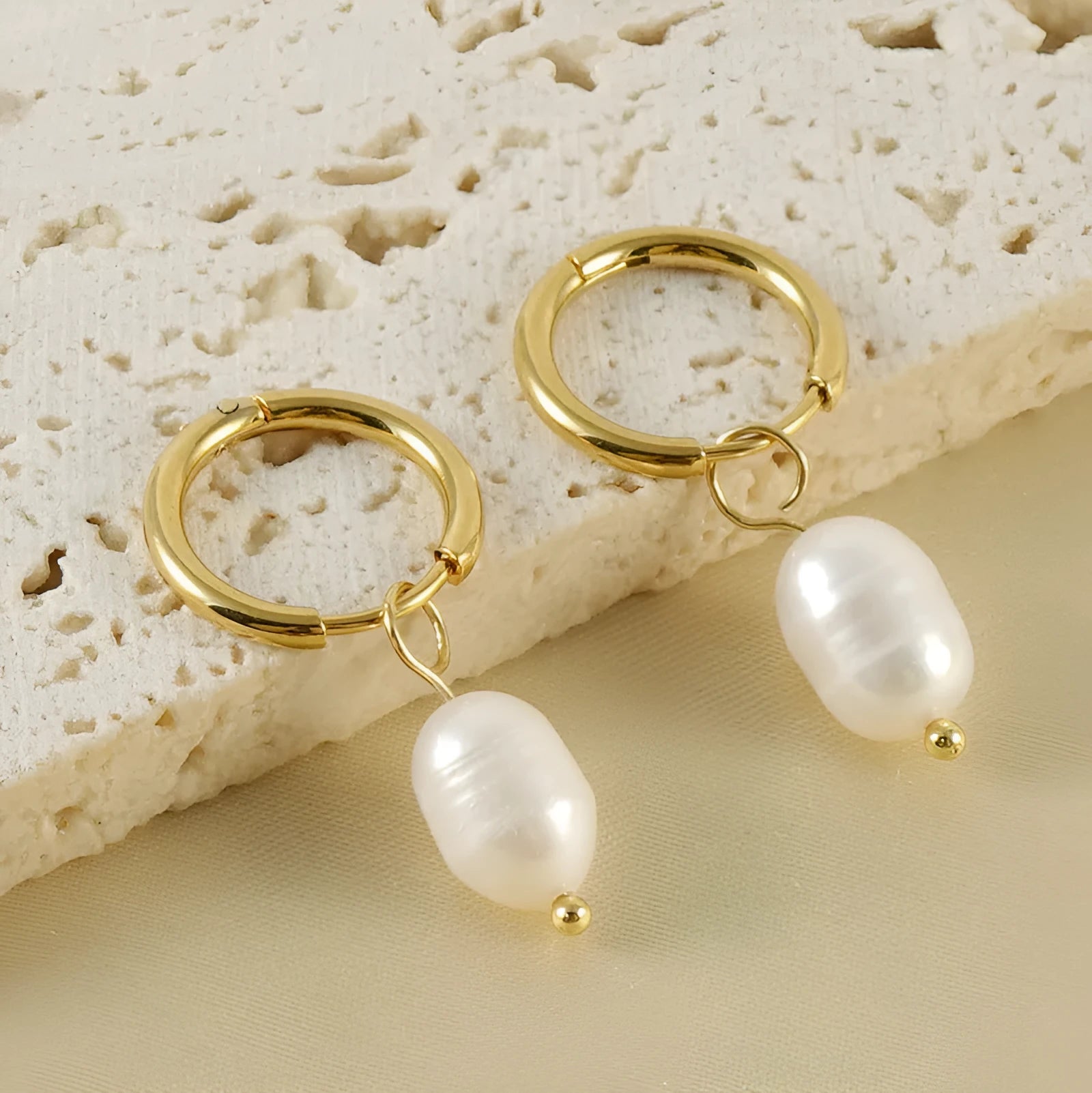 Gold geometric stainless steel earrings with a white pearl accent for women.
