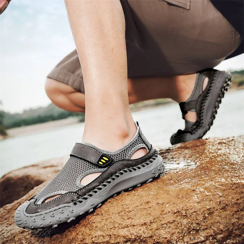 Men's casual sandals with black mesh upper, rubber sole, and adjustable Velcro strap.