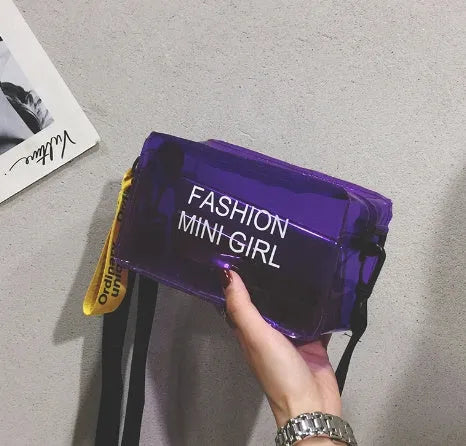A transparent square jelly cross-body bag in a choice of colours, shown with an adjustable strap and a mobile phone inside.