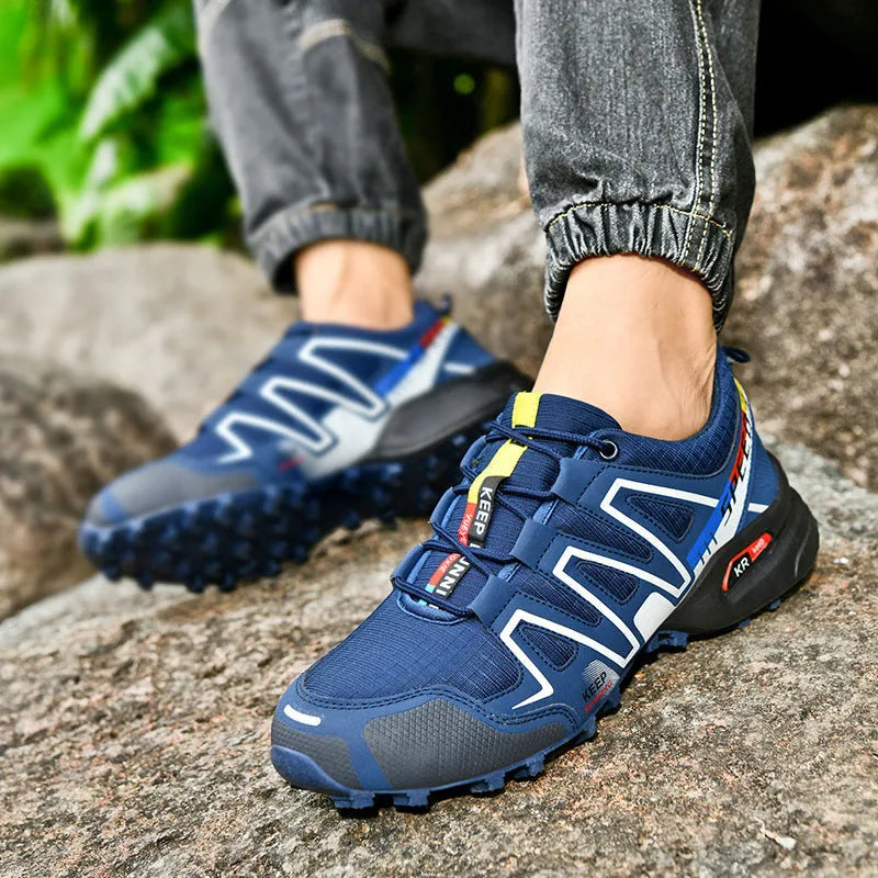 Men's grey orange and dark blue casual running shoes with low-top design on a white background.