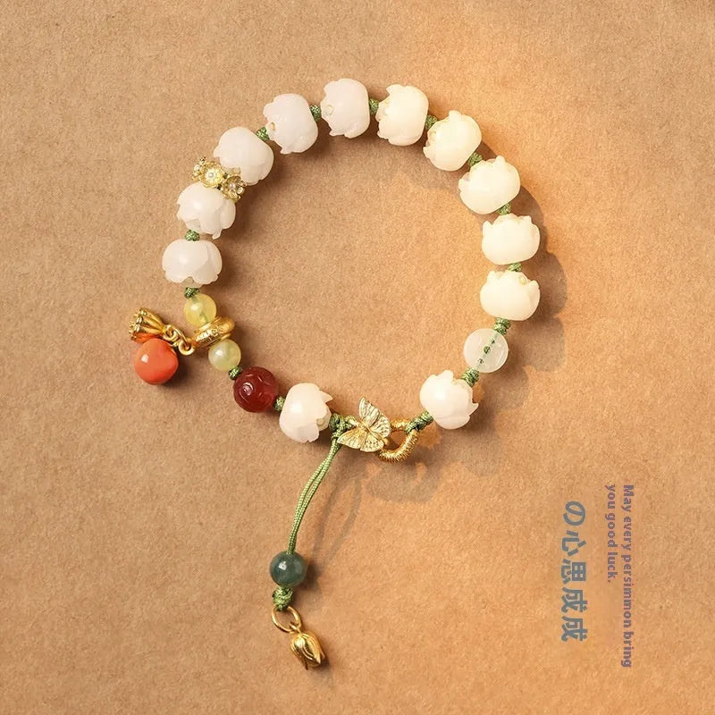 Hand-woven white jade bodhi bracelet with lotus and large pumpkin beads on a single ring open rope.