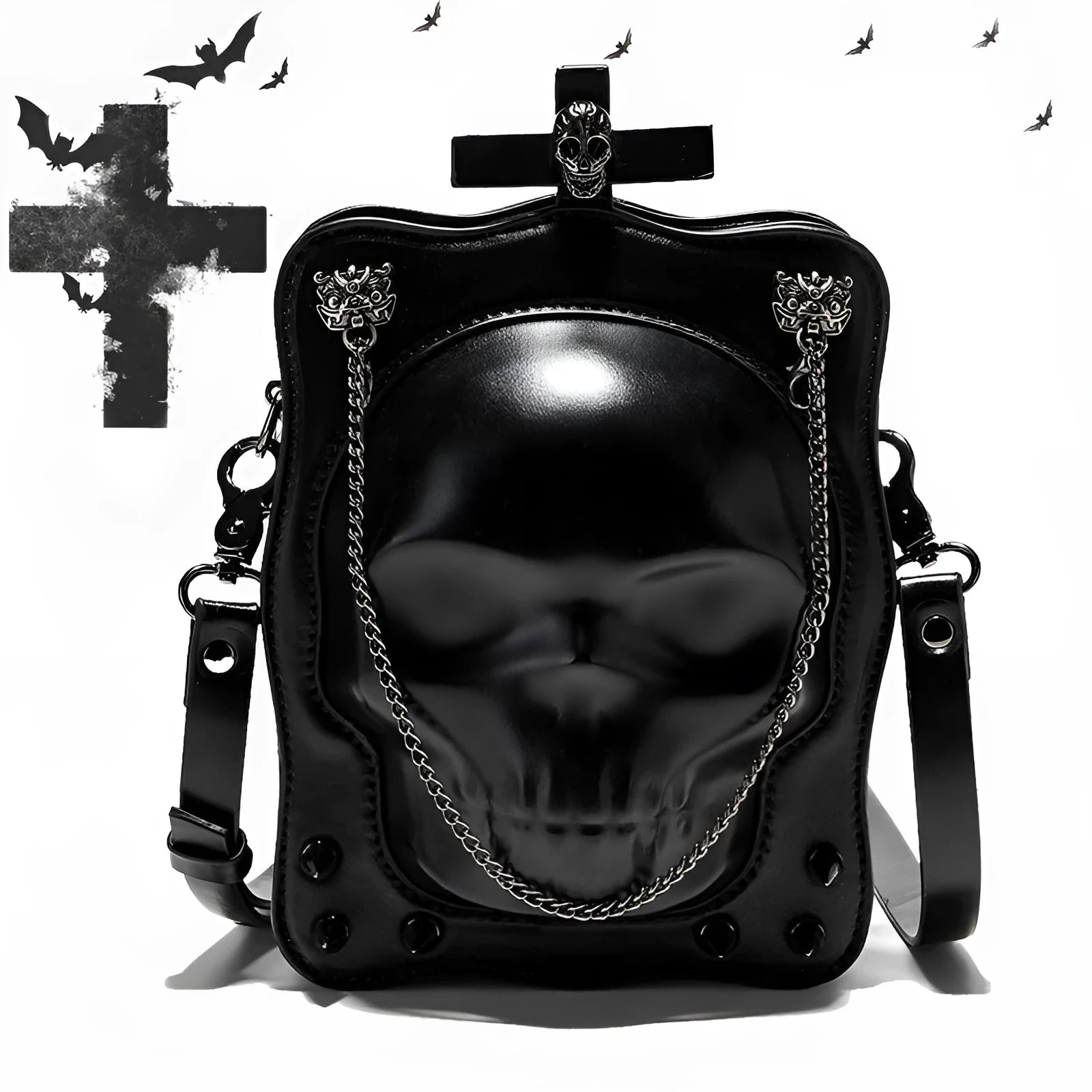 Black square crossbody bag with embossed skull design and metal chain strap against dark background