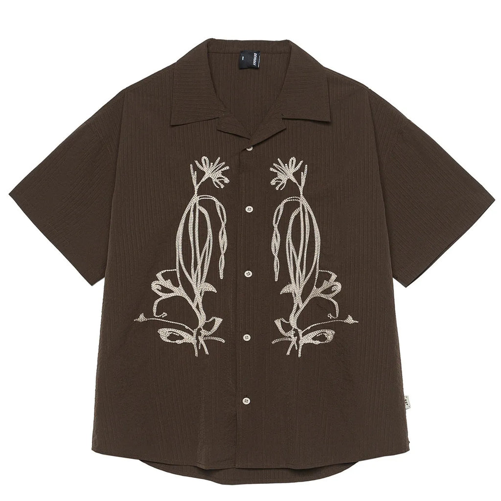 Man wearing brown striped waterproof short sleeve shirt with Cuban collar for outdoor camping.