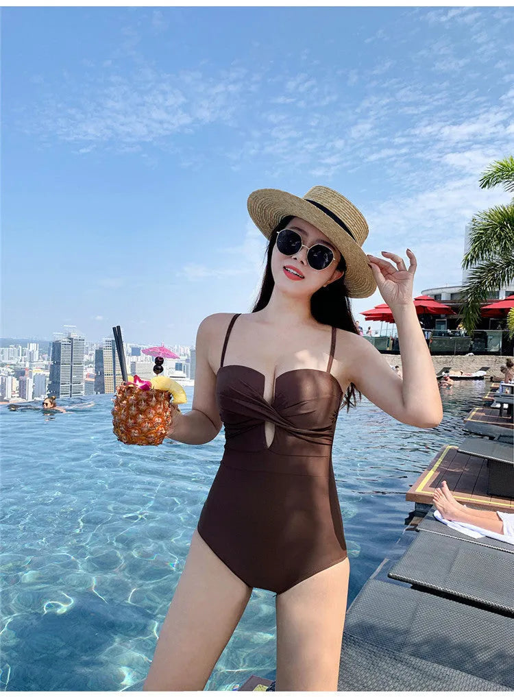 Women's solid colour one-piece swimsuit with push-up design and spaghetti straps in polyester