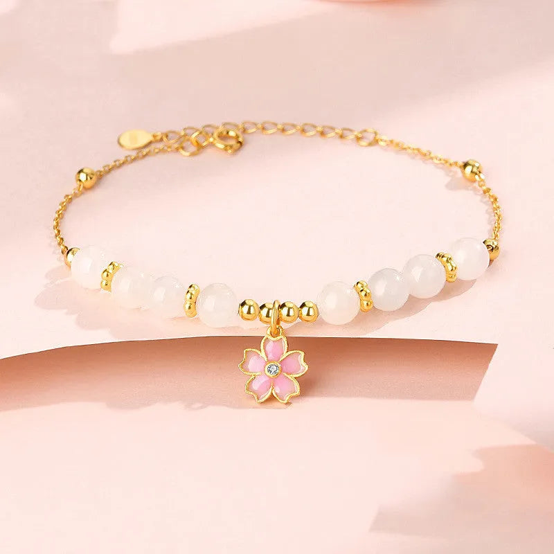 Pink women's bracelet with 925 silver cherry blossom pendant, Hetian jade beads, and gradient epoxy details.